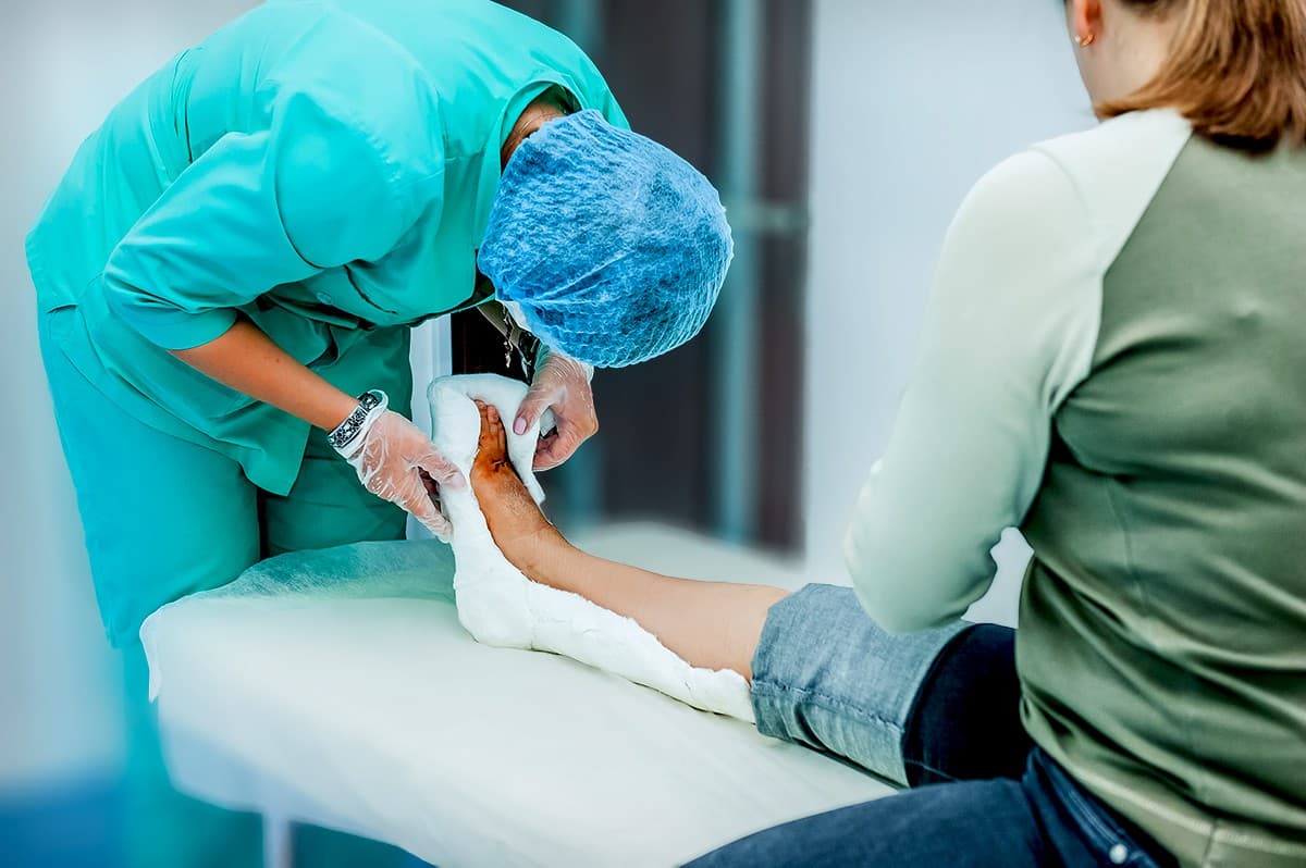 Clinicians dressing a patient's wound